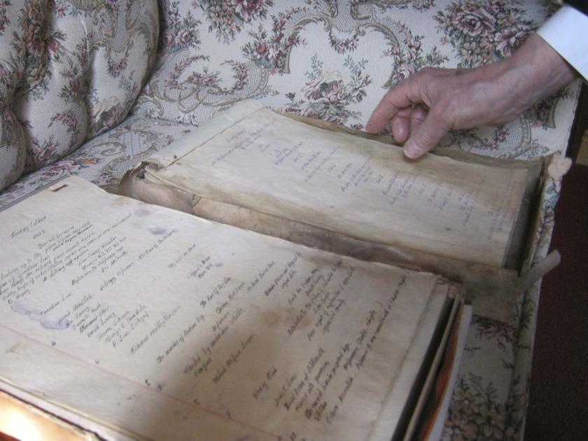 Dudley Martin looks at handwritten manuscripts written by Robert Stroud at his home in Springfield, Missouri, February 12, 2014. — Reuters pic