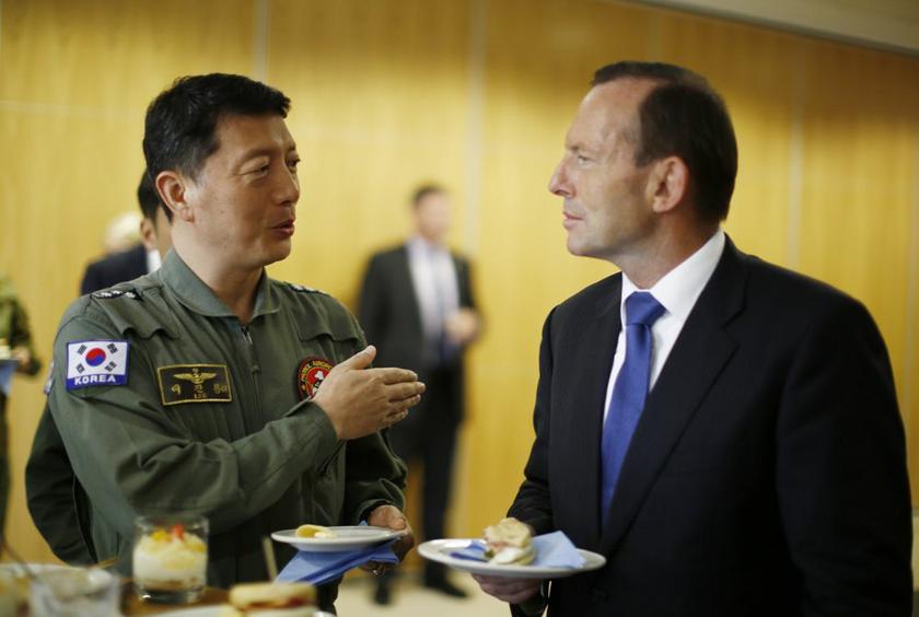 Australia's Prime Minister Tony Abbott (right) meets with South Korea's Navy Captain Lee Jin-young during his visit to RAAF Base Pearce near Perth March 31, 2014. u00e2u20acu2022 Reuters picn