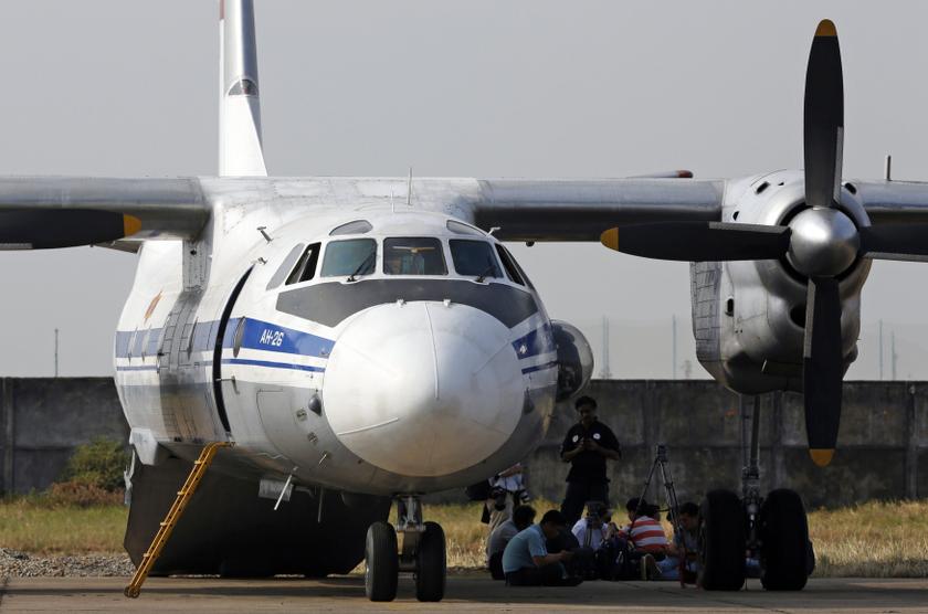 Rescue officials and journalists wait to depart with a Vietnam Air Force search and rescue aircraft An-26 on a mission to find the Malaysia Airlines flight MH370 that disappeared from radar screens in the early hours of Saturday, at a military airport in 
