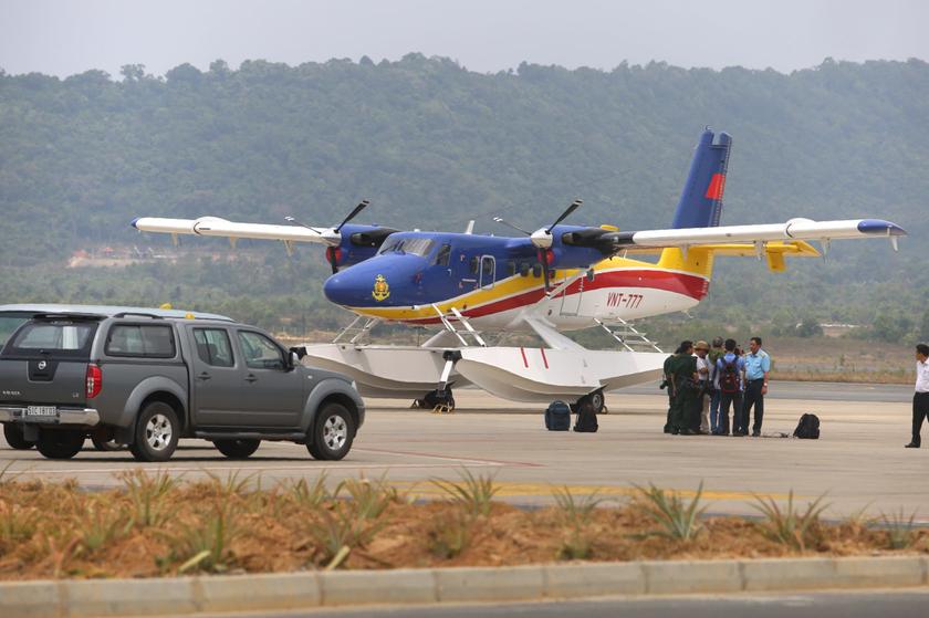 Reporters doing an interview next to one of the planes that has just returned from a search for the missing MH370 aircraft, at Phu Quoc airport, on March 11, 2014. u00e2u20acu201d Picture by Choo Choy May