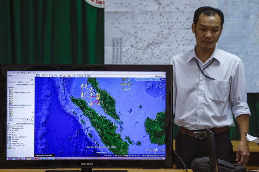 A Vietnamese officer stands next to a TV screen showing a flight route during a news conference about their mission to find missing Malaysia Airlines flight MH370 at Phu Quoc Airport in Phu Quoc Island, March 11, 2014. u00e2u20acu201d Reuters pic
