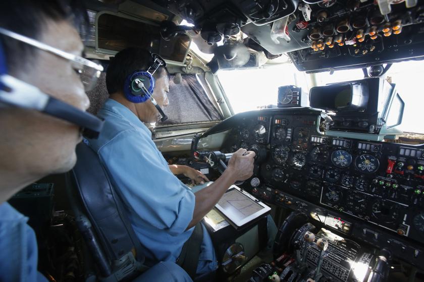 Senior Lieutenant and flight captain Vu Duc Long (right) looks at a map of a search area on iPad while flying a Vietnam Air Force AN-26 aircraft, during a mission to find the missing Malaysia Airlines flight MH370, off Con Dao island, March 14, 2014.u00c2u00a0u00e2u20acu201d