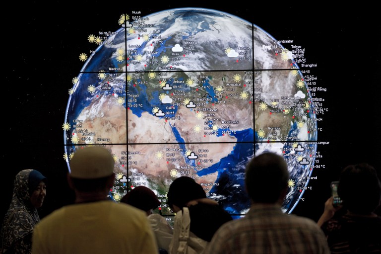 Passengers look at a digital earth displayed at Kuala Lumpur International Airport (KLIA) in Sepang, outside Kuala Lumpur on March 16, 2014. u00e2u20acu201d AFP pic