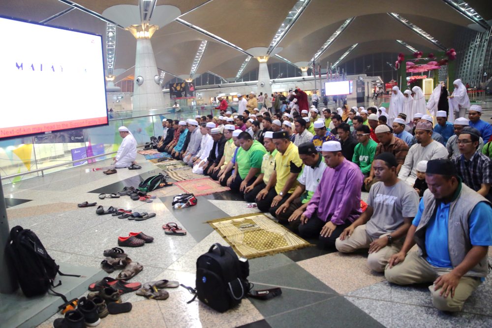 Muslims perform their maghrib prayers and bacaan Yasin for the passengers on the missing flight MH370 at KLIA, on March 13, 2014. — Picture by Choo Choy May