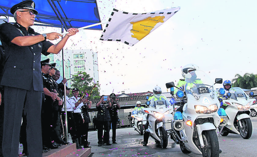 Acryl flags off a 55-member police motorcycle expedition in Ipoh yesterday which would take them to five state destinations in conjunction with the Police Day celebrations.  u00e2u20acu201d Picture by Malay Mail