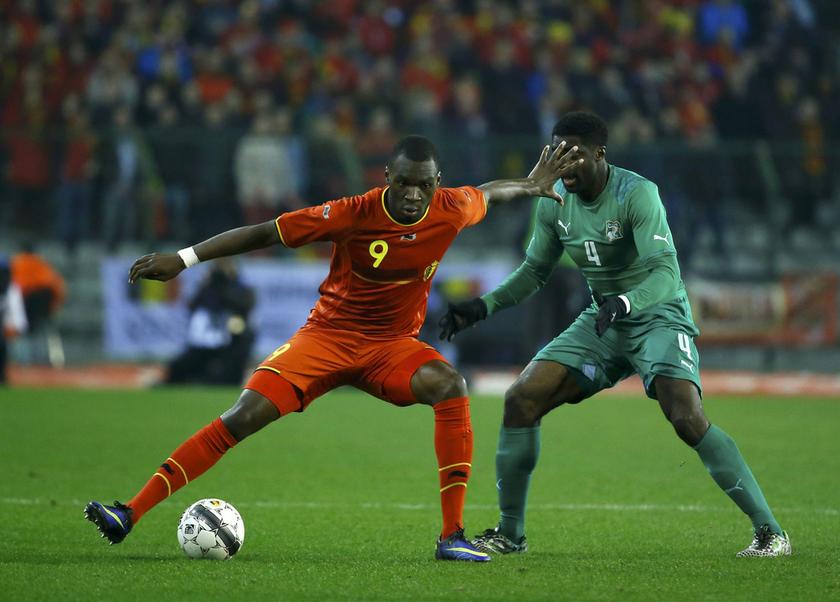 Belgium's Christian Benteke (left) defends possession of the ball from Ivory Coast's Kolo Toure (right) during their international friendly football match at King Baudouin Stadium in Brussels March 5, 2014. u00e2u20acu201d Reuters pic