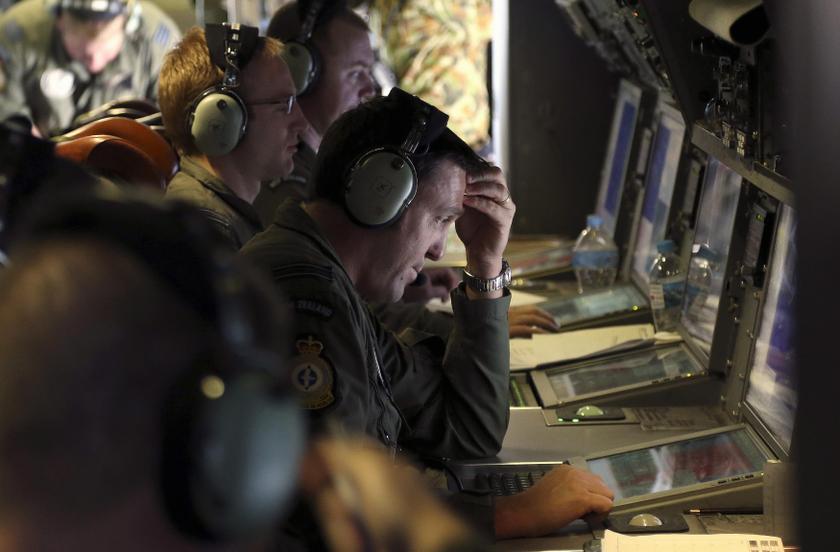 A crew member aboard a Royal New Zealand Air Force (RNZAF) P3 Orion maritime search aircraft reacts as he looks at screens while flying over the southern Indian Ocean looking for missing Malaysian Airlines flight MH370 April 4, 2014. u00e2u20acu201d Reuters pic