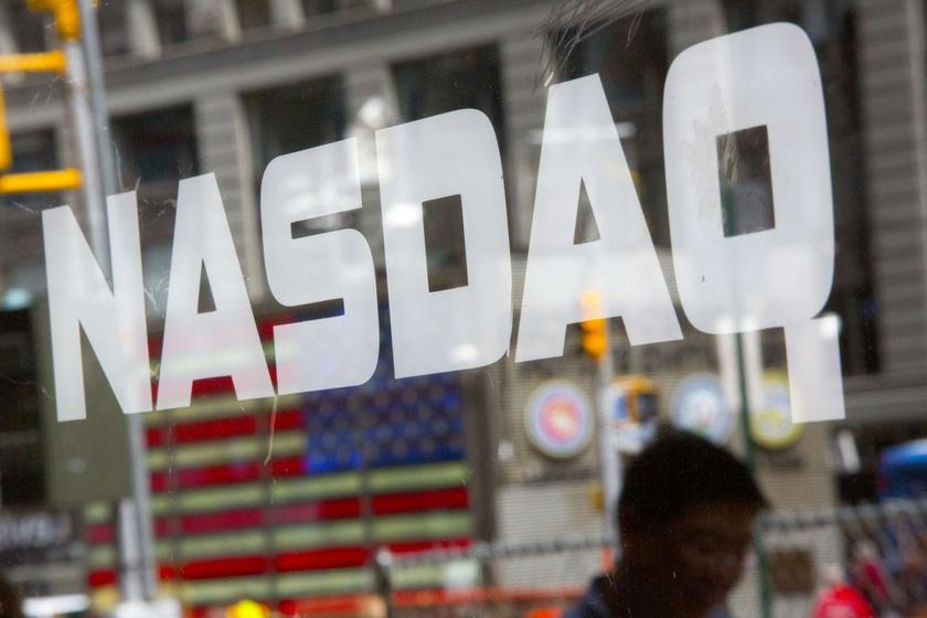 A man walks past the Nasdaq MarketSite in New York's Times Square, August 23, 2013. u00e2u20acu201d Reuters pic