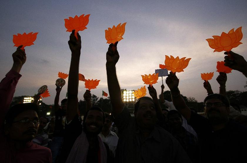 Supporters of Hindu nationalist Narendra Modi, prime ministerial candidate for India's main opposition Bharatiya Janata Party (BJP), wave the party's symbol during an election campaign rally in the southern Indian city of Chennai April 13, 2014 Reuters