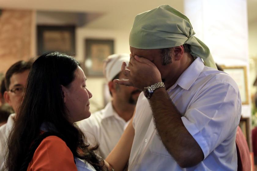 Teoh Lee Lan, younger sister to Beng Hock (left) consoling a distraught Gobind Singh Deo at the wake of the late Karpal Singh. u00e2u20acu201d Picture by Siow Feng Saw.