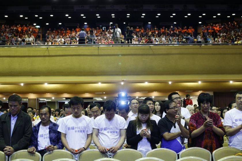 Chinese relatives (bottom) of passengers onboard the missing Malaysia Airlines flight MH370 take part in a special prayer at the Malaysian Chinese Association (MCA) headquarters in Kuala Lumpur April 6, 2014. u00e2u20acu201d Reuters pic