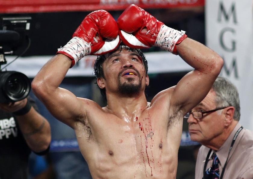 Manny Pacquiao of the Philippines celebrates his unanimous decision victory over WBO welterweight champion Timothy Bradley of the US during their title fight at the MGM Grand Garden Arena in Las Vegas, Nevada April 12, 2014. u00e2u20acu201d Reuters pic