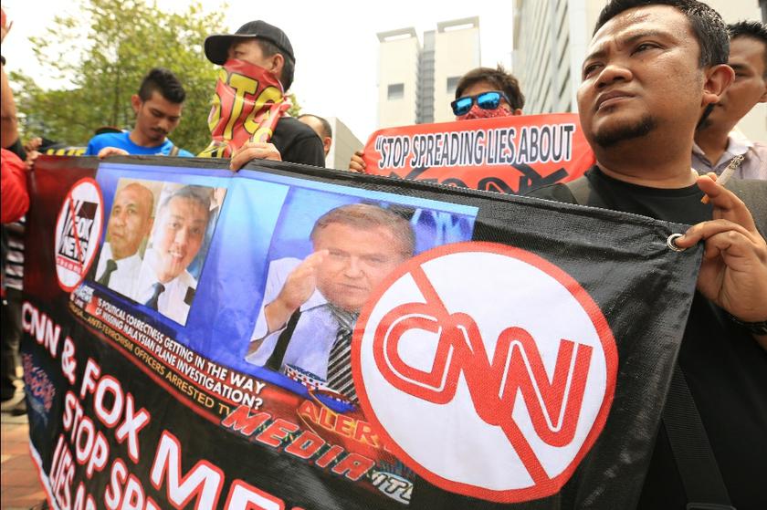 Members of several Muslim NGOs hold banners at a protest against CNN and Fox News outside the US Embassy in Kuala Lumpur, on April 3, 2014. u00e2u20acu201d Picture by Saw Siow Feng