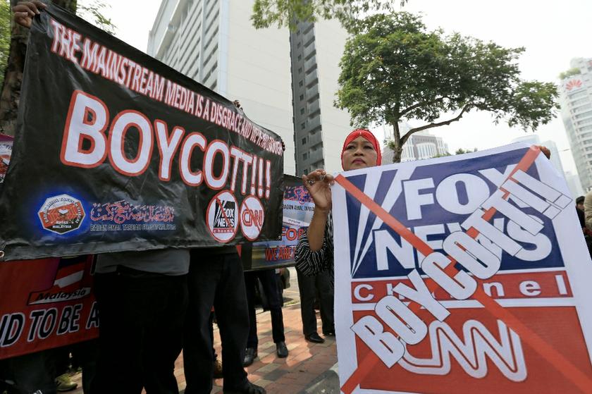 The protesters hold banners in the demonstration against CNN and Fox News outside the US Embassy.