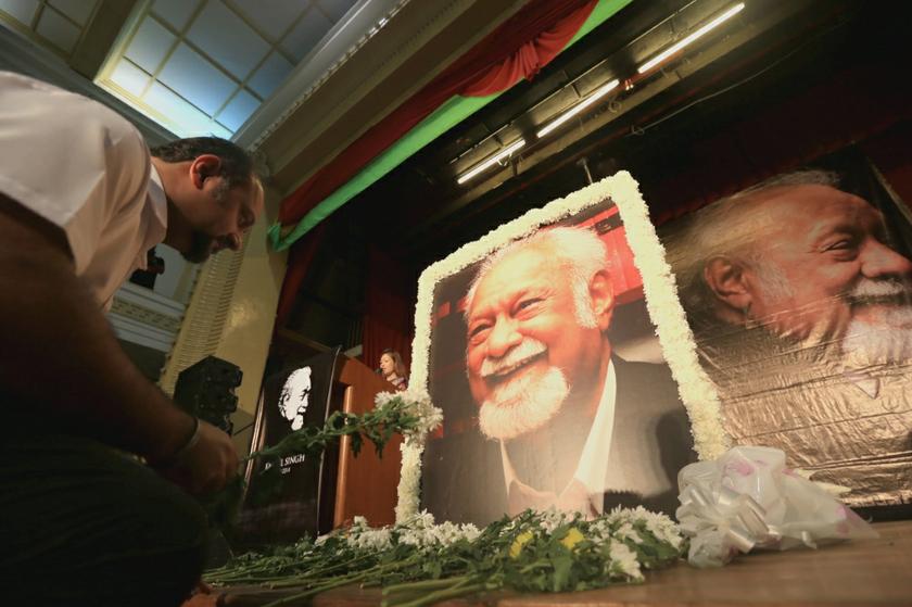 Karpal Singh's son, Gobind, places flowers under a picture of Karpal at the memorial event, on April 24, 2014. u00e2u20acu201d Picture by Saw Siow Feng