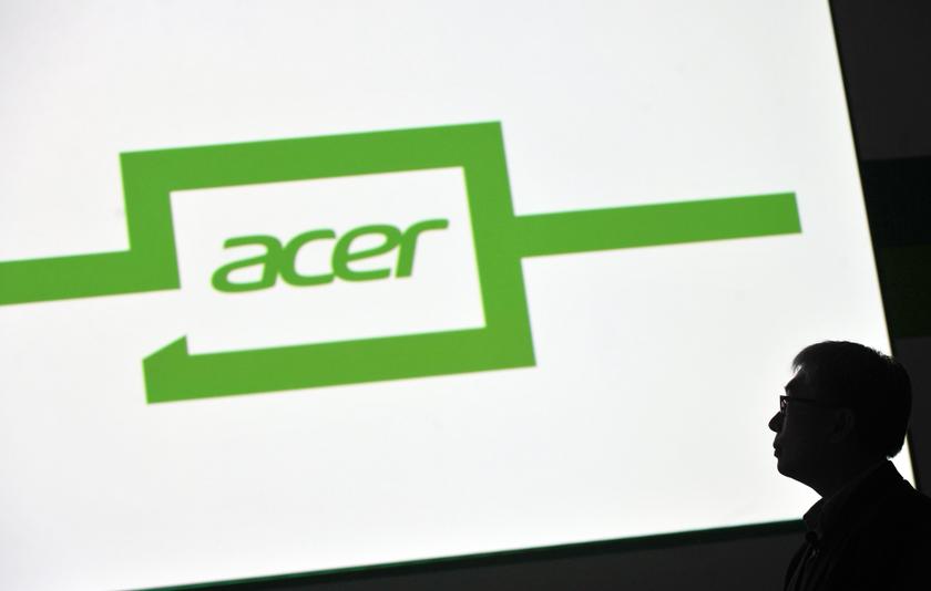 Jim Wong, Corporate President of Acer Group, speaks in front of a company logo. u00e2u20acu201d AFP pic