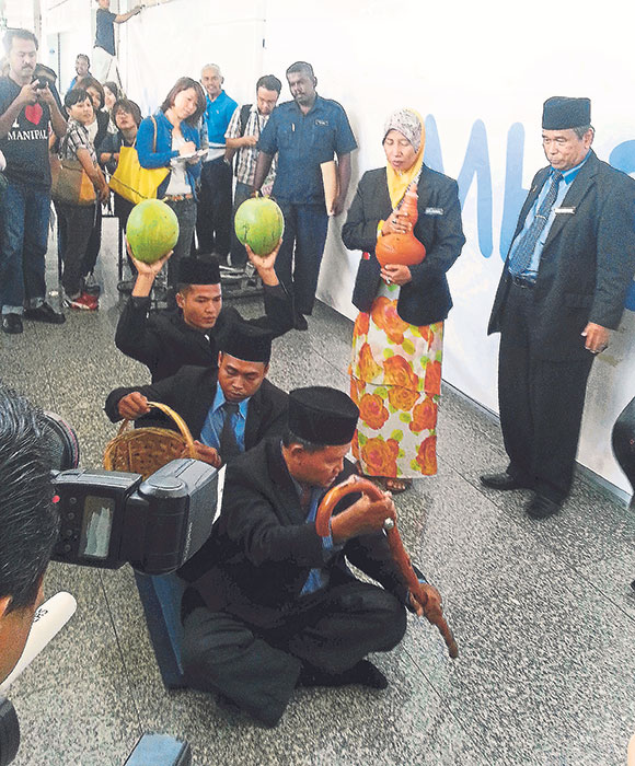 Ibrahim and his team perform some rituals at KLIA, March 12, 2014.