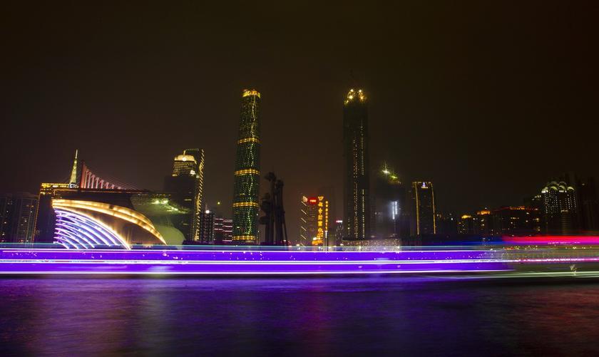 A long exposure picture of boats passing by a business area along the Pearl River in Guangzhou, Guangdong province, March 22, 2014. u00e2u20acu201d Reuters pic