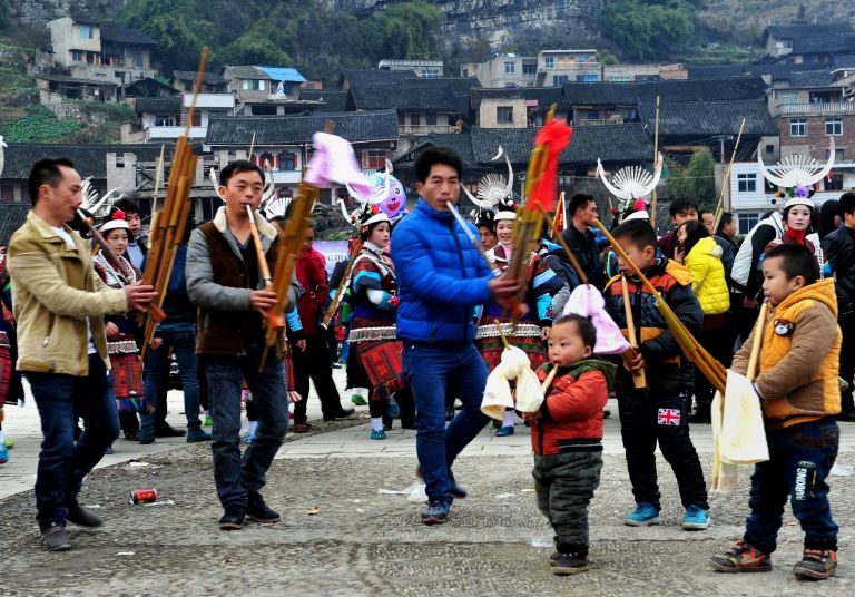 People celebrating the Reed Pipe Festival of the Miao ethnic group in Zhouxi township, Kaili, in southwest China's Guizhou province, February 19, 2014. — AFP pic
