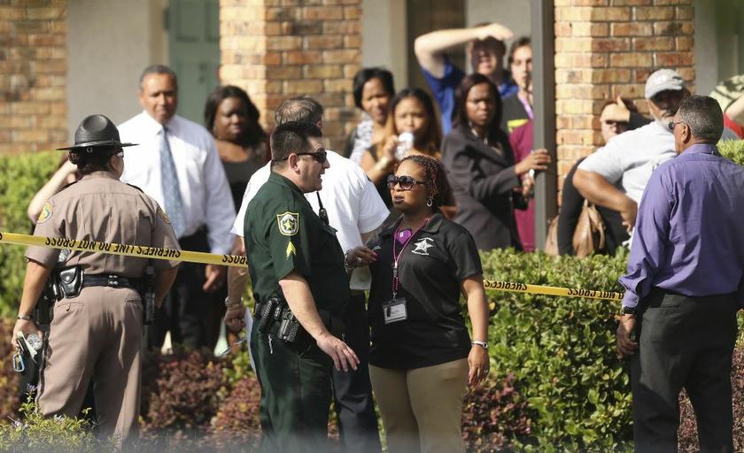 Parents speak to the police after several children were injured after being struck by a vehicle at a KinderCare Learning Centre in Winter Park, Florida April 9, 2014. ― Reuters pic