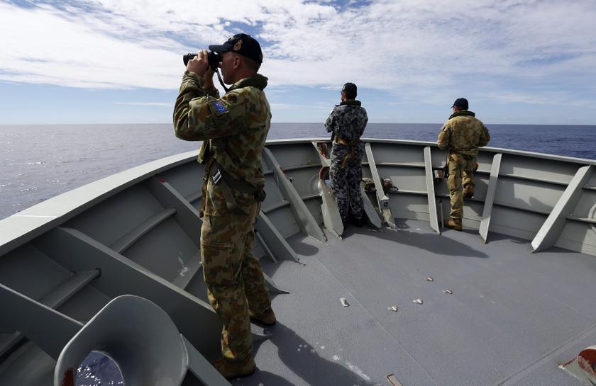Gunner Richard Brown (left) looks through binoculars with other crew members aboard the Australian Navy ship HMAS Perth as they continue to search for missing MAS flight MH370, April 10, 2014. u00e2u20acu201d Reuters pic