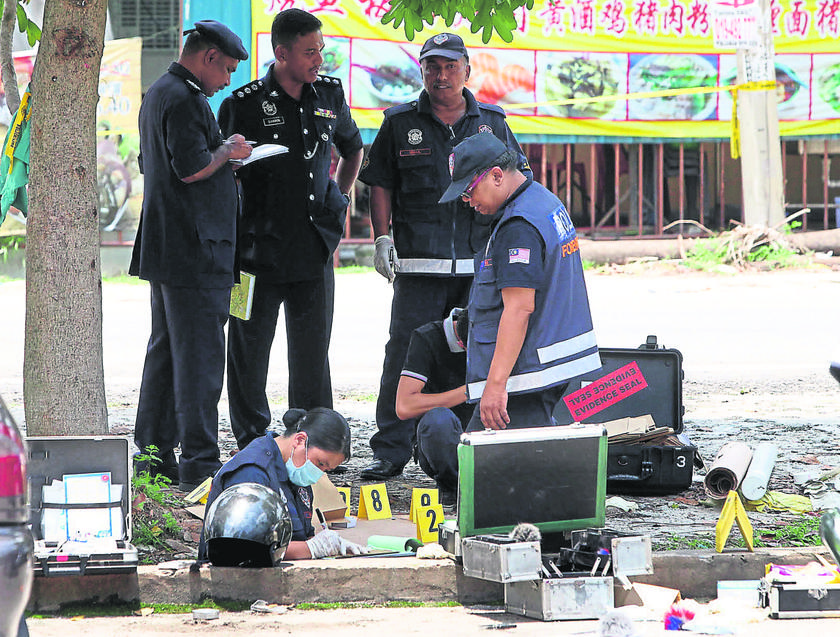 A police forensic team scouting for evidence. u00e2u20acu201d Malay Mail pic