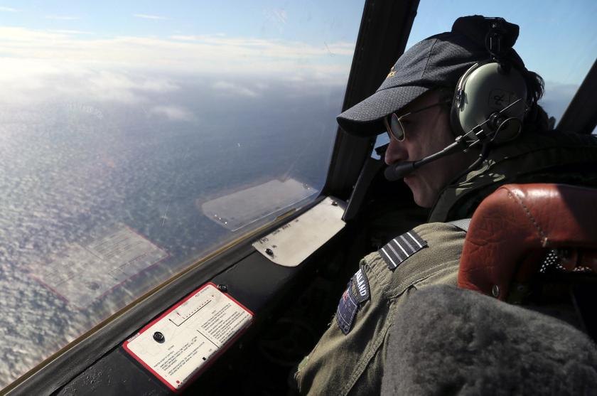 Royal New Zealand Air Force (RNZAF) captain, Wing Commander Rob Shearer, looks out from the cockpit of a P3 Orion maritime search aircraft while flying over the southern Indian Ocean looking for missing Malaysian Airlines flight MH370 March 31, 2014.