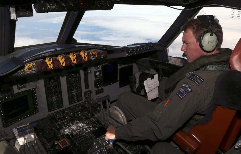 Royal New Zealand Air Force (RNZAF) co-pilot Squadron Leader Brett McKenzie sits in the cockpit of a P3 Orion maritime search aircraft while flying over the southern Indian Ocean looking for missing Malaysian Airlines flight MH370 March 31, 2014. Reuters 