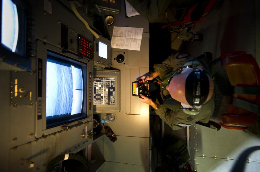 Royal Australian Air Force (RAAF) Warrant Officer Michael Wright uses the advanced optical systems aboard a RAAF AP-3C Orion aircraft during the search in the southern Indian Ocean for debris from the missing Malaysian Airlines flight MH370 April 1, 2014.