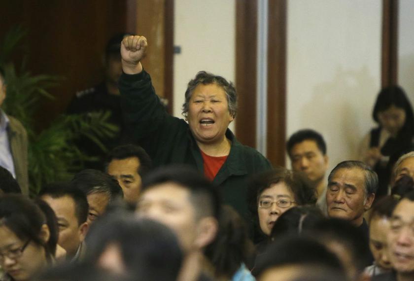 A relative of a passenger aboard Malaysia Airlines flight MH370 gestures as she shouts at Malaysian representatives during a briefing at Lido Hotel in Beijing April 21, 2014. u00e2u20acu2022 Reuters pic