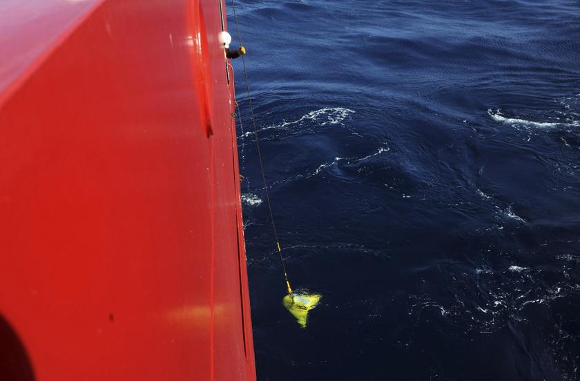 A worker lowers from the Australian Defence Vessel Ocean Shield the US Navy Supervisor of Salvage and Diving (SUPSALV) towed pinger locator into the southern Indian Ocean as part of the continuing search for MH370 in this picture released by the US Navy A