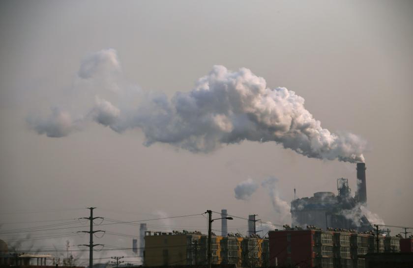 Smoke rises from a chimney of a steel plant next to residential buildings on a hazy day in Fengnan district of Tangshan, Hebei province in this February 18, 2014 file photo. u00e2u20acu201d Reuters pic