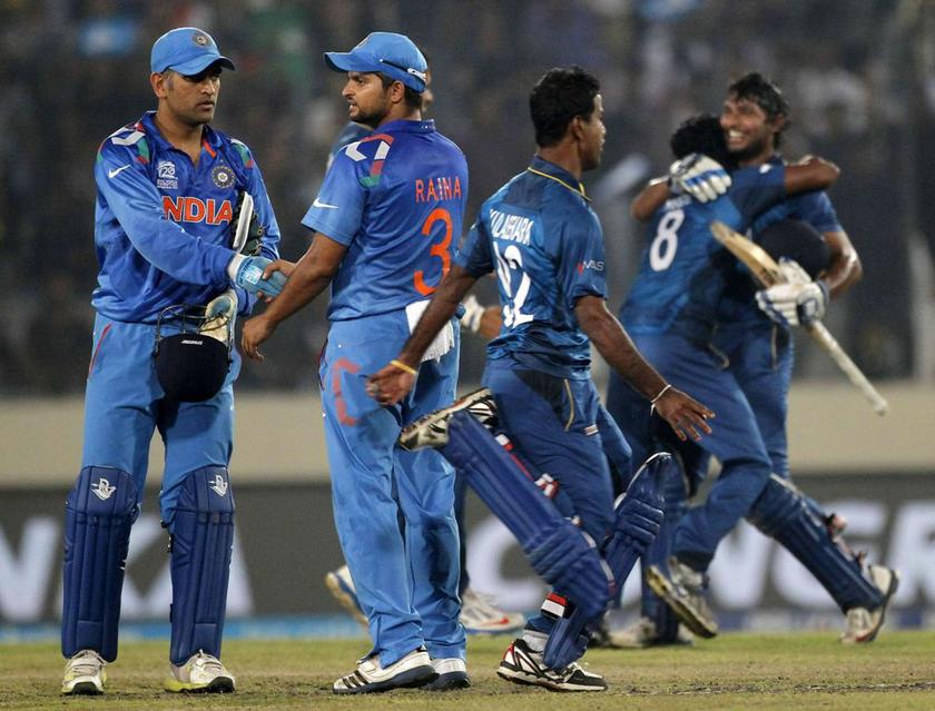 Sri Lanka's players celebrate after they won the ICC Twenty20 World Cup cricket title as India's captain MS Dhoni (left) and Suresh Raina look on at the Sher-E-Bangla National Cricket Stadium in Dhaka April 6, 2014. u00e2u20acu2022 Reuters pic