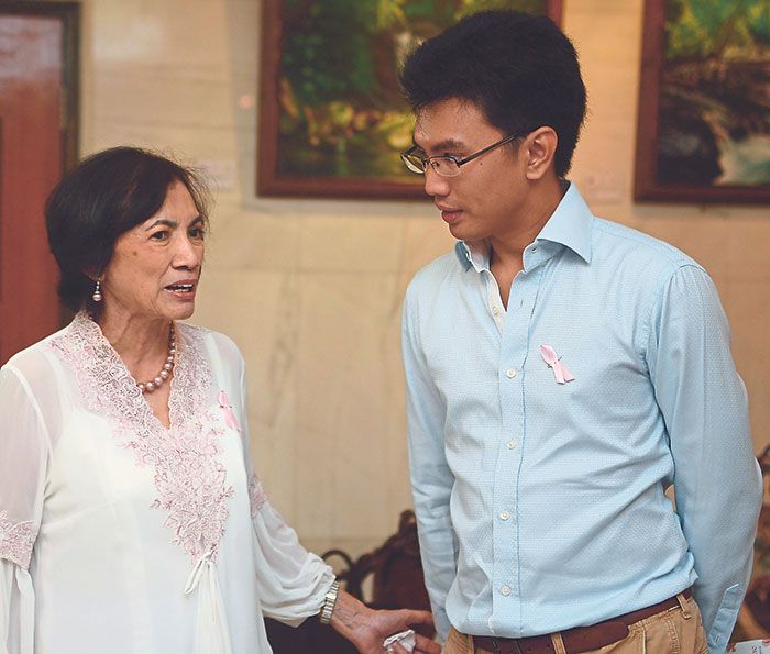 The writer with Tunku Munirah (left) at the exhibition that was organised in support of the National Cancer Society Malaysia’s Pink Unity support group at the Yayasan Seni Art Gallery.