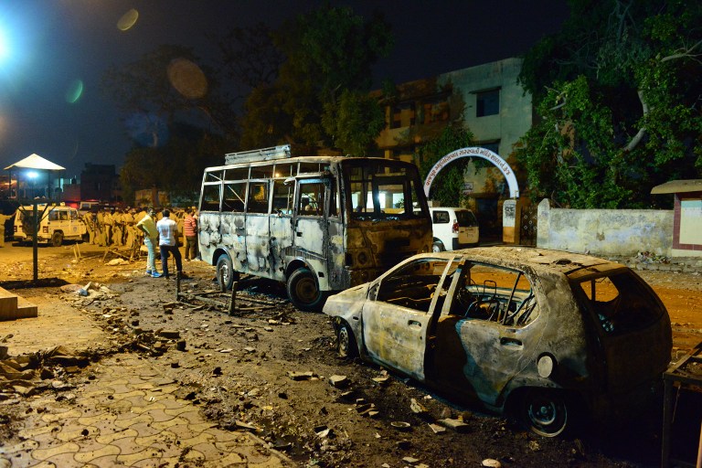 Indian police secure the site of clashes between two groups during which shops and vehicles were set alight in the Gomptipur area of Ahmedabad, May 25, 2014. u00e2u20acu2022 AFP pic