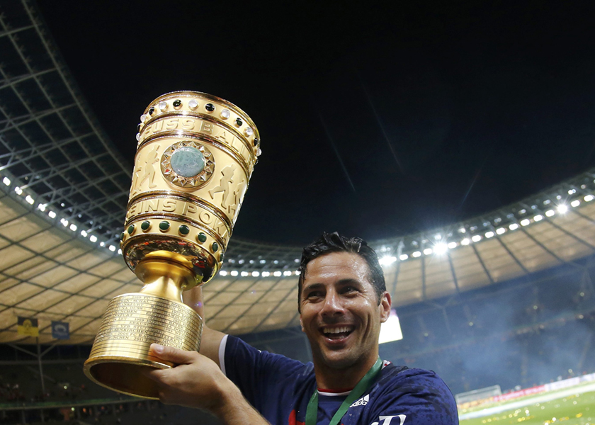 Bayern Munich's Claudio Pizarro holds the trophy as he celebrates winning their German Cup (DFB Pokal) final match against Borussia Dortmund in Berlin, May 18, 2014. u00e2u20acu201d Reuters pic