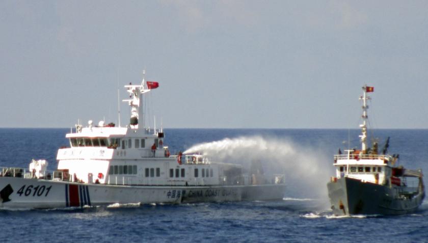 A Chinese coastguard vessel (left) uses water cannon on a Vietnamese Sea Guard ship on the South China Sea near the Paracels islands, in this photo released May 8, 2014. u00e2u20acu201d Reuters pic