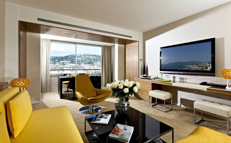 The living room of the Jacqueline Suite at the Grand Hotel, with a view over the hills behind the city of Cannes.— AFP pic
