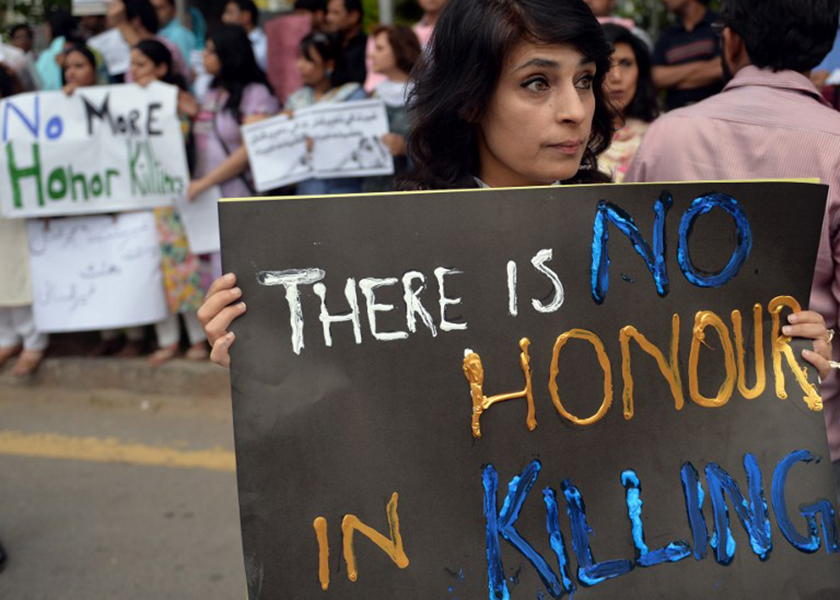 Pakistani human rights activists hold placards during a protest in Islamabad on May 29, 2014 against the killing of pregnant woman Farzana Parveen was beaten to death with bricks by members of her own family for marrying a man of her own choice in Lahore.