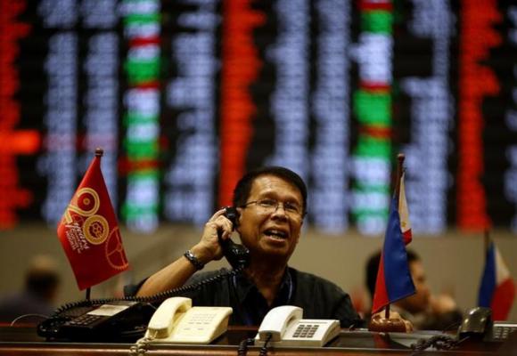 A stock broker takes orders on the telephone during trading at the Philippine Stock Exchange in Manila's Makati financial district February 7, 2014. u00e2u20acu201d  Reuters pic