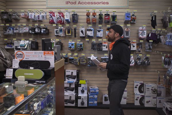 Occupy Wall Street activist Andrew Guest shops for a battery pack capable of charging multiple electronic devices, in New York, April 30, 2012. Reuters