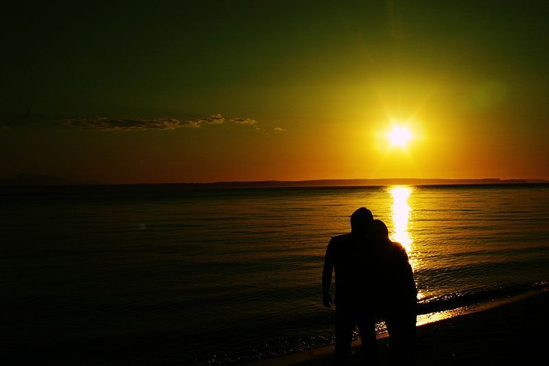 Lovers generic: A couple of lovers looking westwards as the sun sets, contemplating on life, love and a happy ever after ... or maybe not. wikimedia commons