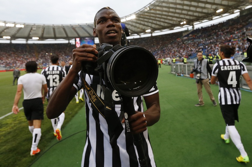 Juventus'  Paul Pogba holds a professional camera as he celebrates their win against AS Roma at the end of their Italian Serie A match in Rome May 11, 2014.u00c2u00a0u00e2u20acu201d Reuters pic