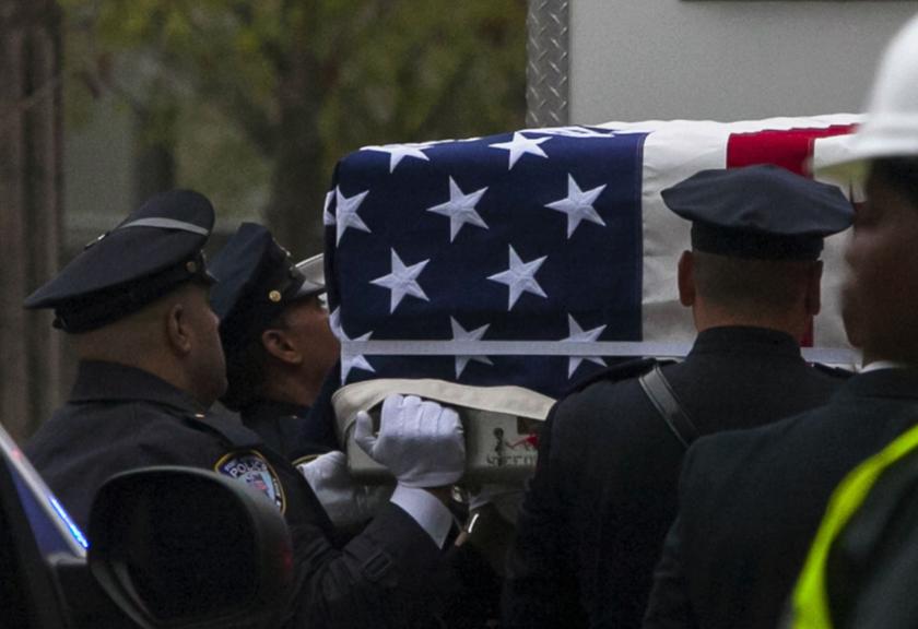 Emergency personnel carry a casket draped with a US flag during the ceremonial transfer of the 9/11 unidentified remains to the Office of the Chief Medical Examiner of the City of New York (OCME) repository at the World Trade Center site, in New York May 