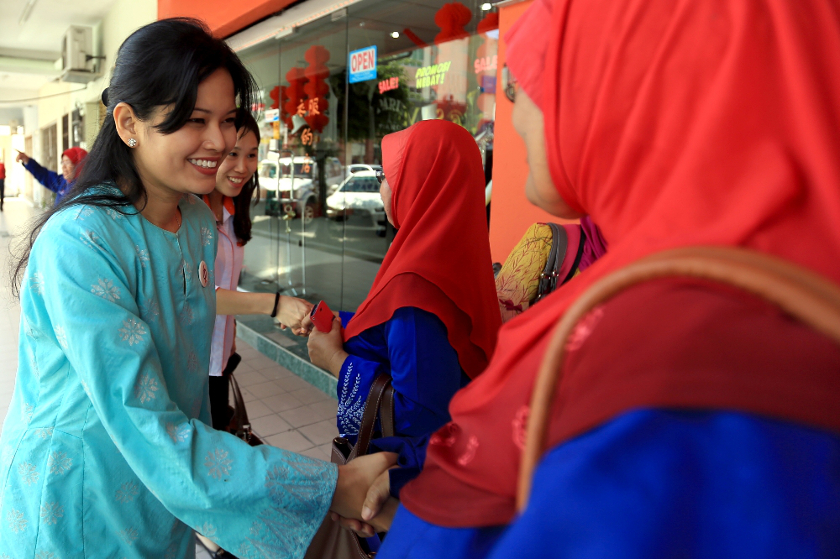 DAP's candidate Dyana Sofya Mohd Daud (left) greets residents during a walkabout session in Teluk Intan, on May 19, 2014. u00e2u20acu201d Picture by Saw Siow Feng