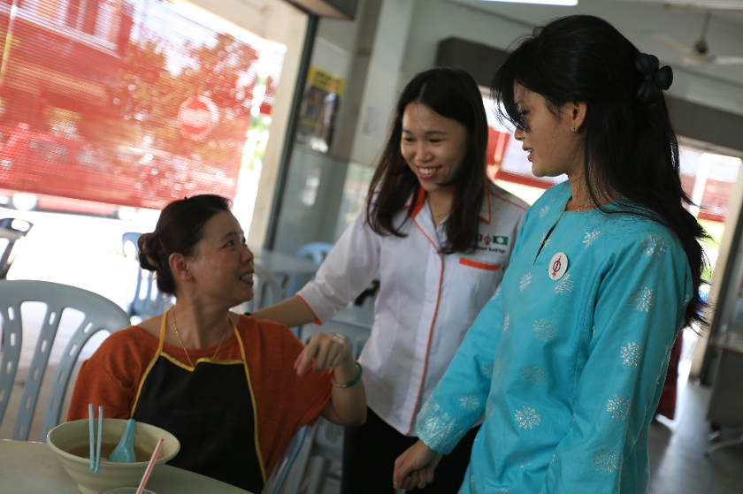 DAP's candidate Dyana Sofya Mohd Daud (right) greets residents during a walkabout session in Teluk Intan, on May 19, 2014. u00e2u20acu201d Picture by Saw Siow Feng