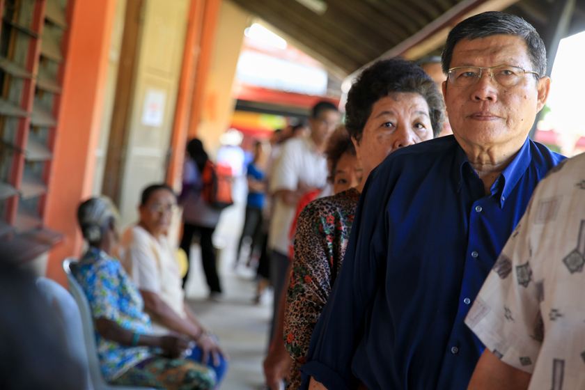 Voters wait in line to cast their votes in the Teluk Intan by-election, on May 31, 2014. u00e2u20acu201d Picture by Saw Siow Feng