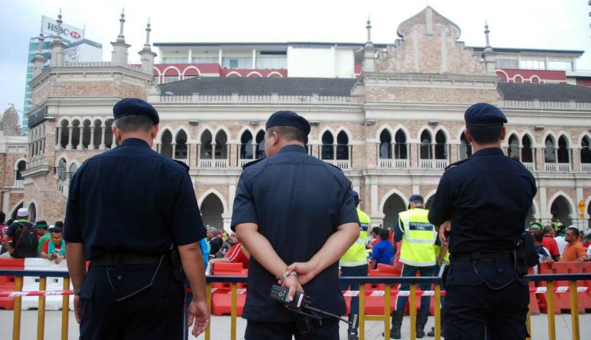 Police officers keep an eye on the crowd during the Goods and Services Tax (GST) rally in front of Dataran Merdeka, on May 1, 2014. u00e2u20acu201d Picture by Yusof Mat Isa