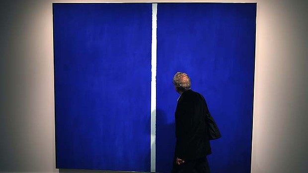 A visitor walks past Barnett Newman's Onement VI during a Sotheby's preview in New York. The large 1953 painting has fetched US#43.8 million (RM141.41 million) at a New York City auction. u00e2u20acu201d Reuters pic