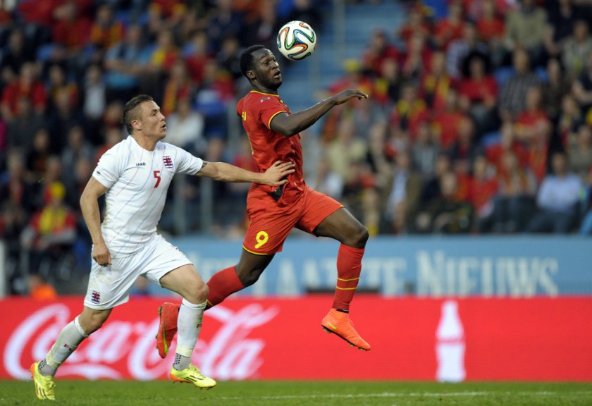 Belgiumu00e2u20acu2122s Romelu Lukaku is chased by Luxembourgu00e2u20acu2122s Tom Schnell (left) during their international friendly match in Genk May 26, 2014. u00e2u20acu201d Reuters pic